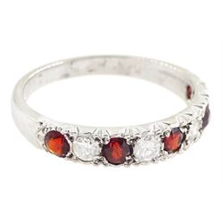 White gold garnet and diamond half eternity ring, nine alternating round brilliant cut diamonds and round cut garnets, stamped 18ct, total diamond weight approx 0.30 carat