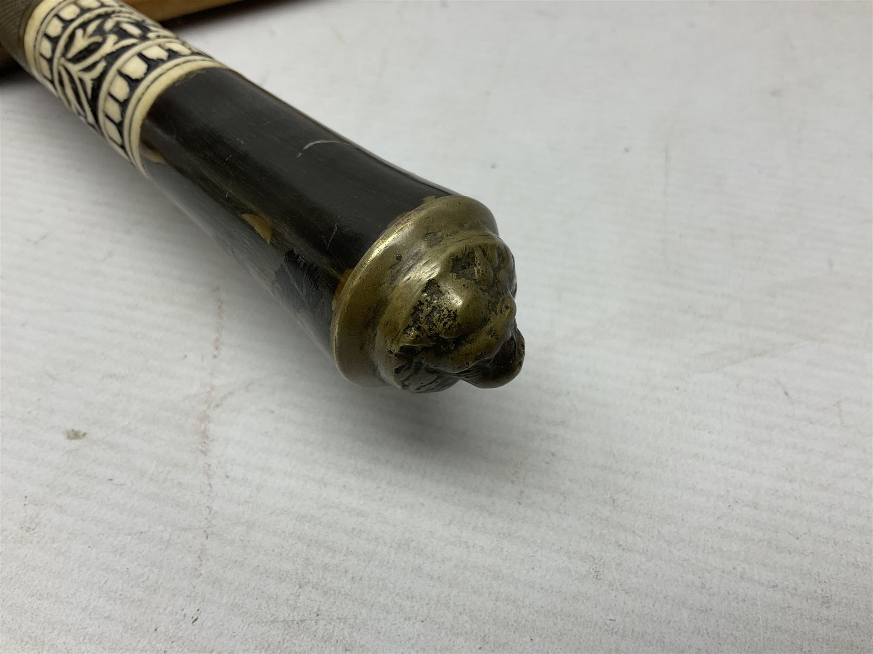 Early 20th century Indian ebonised sword stick, the 59.5cm blade with punched decoration and horn grip L94cm overall; and a reproduction Indian tulwar with scabbard (2)