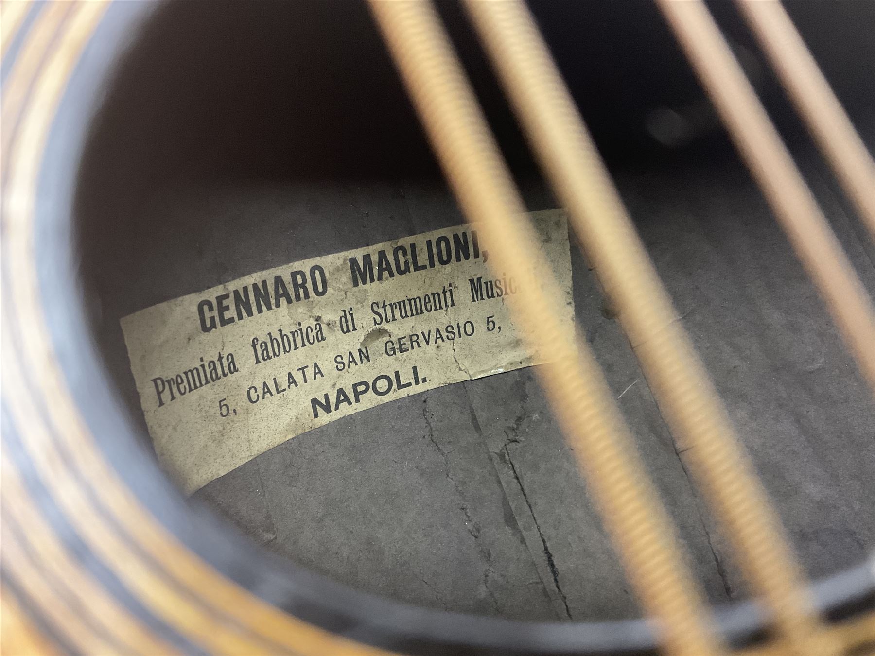 Late 19th century Italian lute back mandolin with segmented bowl back, bears label Gennaro Maglioni Napoli L61cm; in ebonised wooden case; together with another similar damaged Italian lute back mandolin for restoration or spares (2)