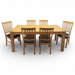 Solid light oak extending dining table with single leaf, and set of six chairs