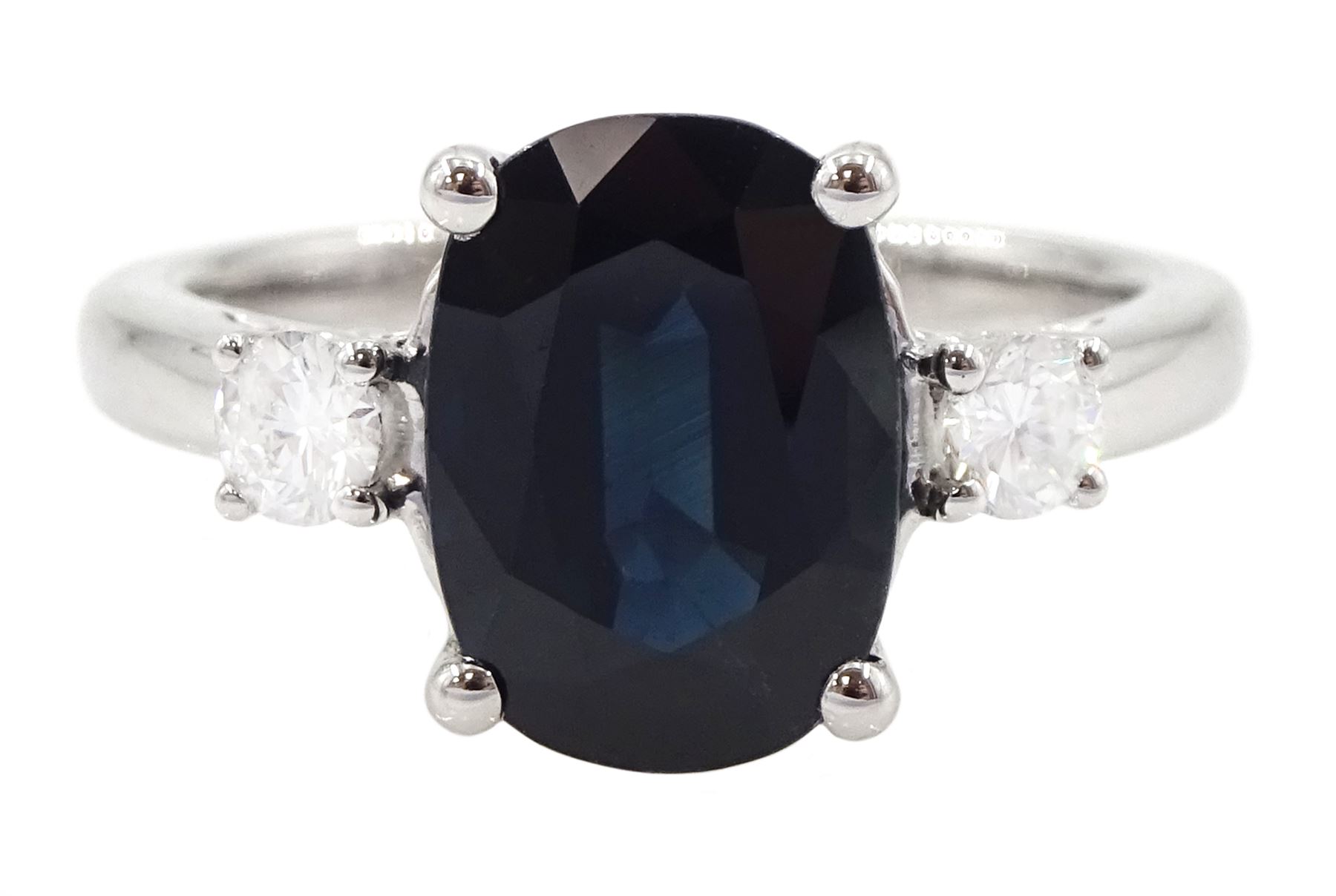 18ct white gold sapphire and diamond three stone ring, single oval cut sapphire of approx 3.00 carat, with a round brilliant cut diamond set either side, hallmarked, total diamond weight approx 0.25 carat