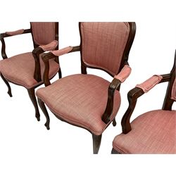 Set four French style stained beech elbow chairs, the cresting rails carved with flower heads, mould arms with scrolled terminals, upholstered in pink herringbone fabric, floral carved cabriole supports