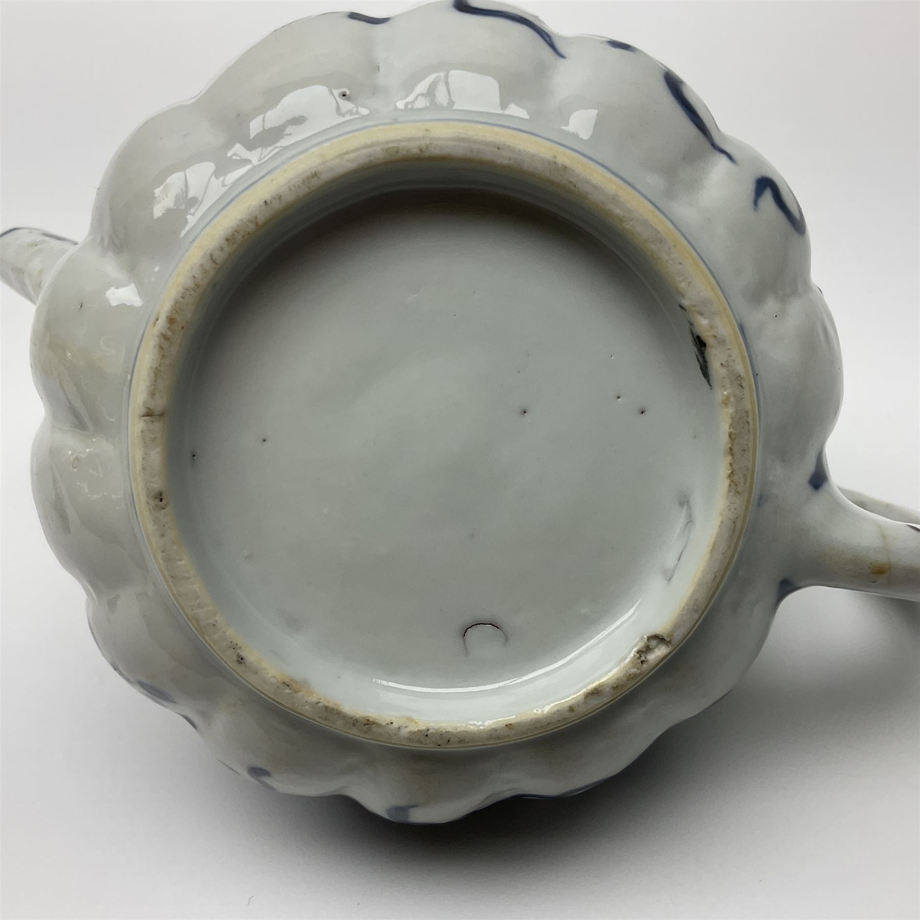 18th century Chinese blue and white teapot, painted with floral sprays, with lobed body and cover, H11cm