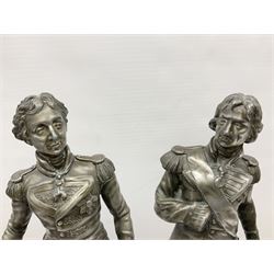 After S. Kinsburger, pair of early 20th century polished spelter figures of Lord Nelson and Arthur Wellesley, each depicted wearing full uniform and standing beside a rock; inscribed S. Kinsburger H39cm; on later turned mahogany bases H47cm overall (2)
