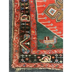 Turkish red ground rug, the field decorated with three large stylised stars, two bird motifs to one end, 256cm x 130cm
