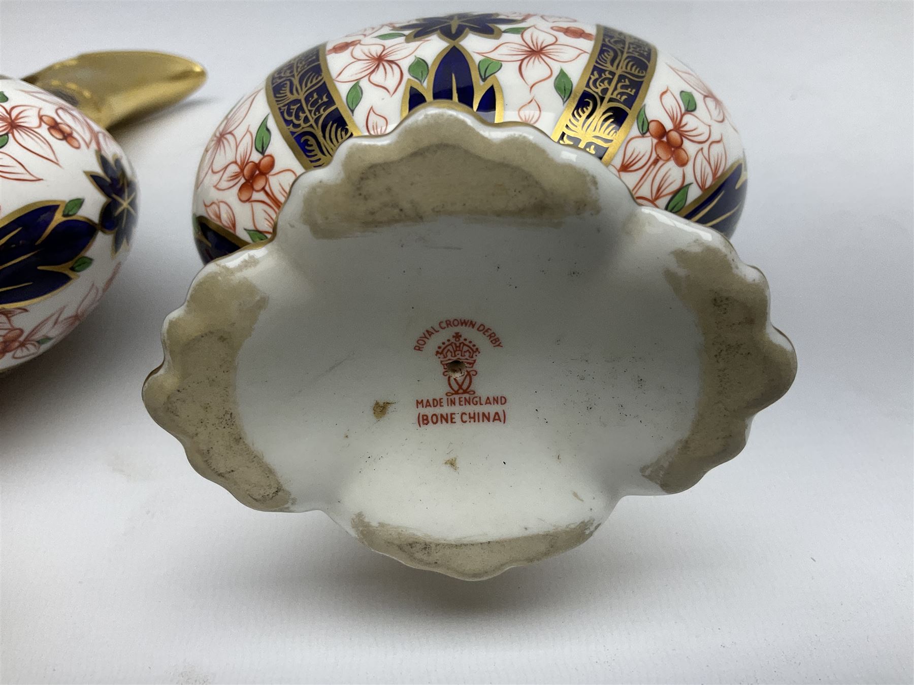 Pair of mid 20th century Royal Crown Derby Imari 1128 pattern Kedleston ewers, each with gilt scroll handle and neck, upon a gilt quatrefoil foot, each with printed marks beneath, H25.5cm