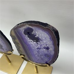 Pair of purple agate slices, polished with rough edges raised upon gilt metal stands