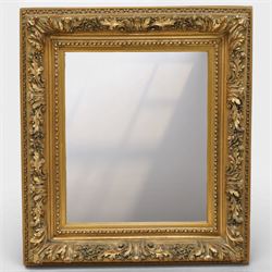 Rococo revival style giltwood and gesso wall mirror, the rectangular frame with layered mo...