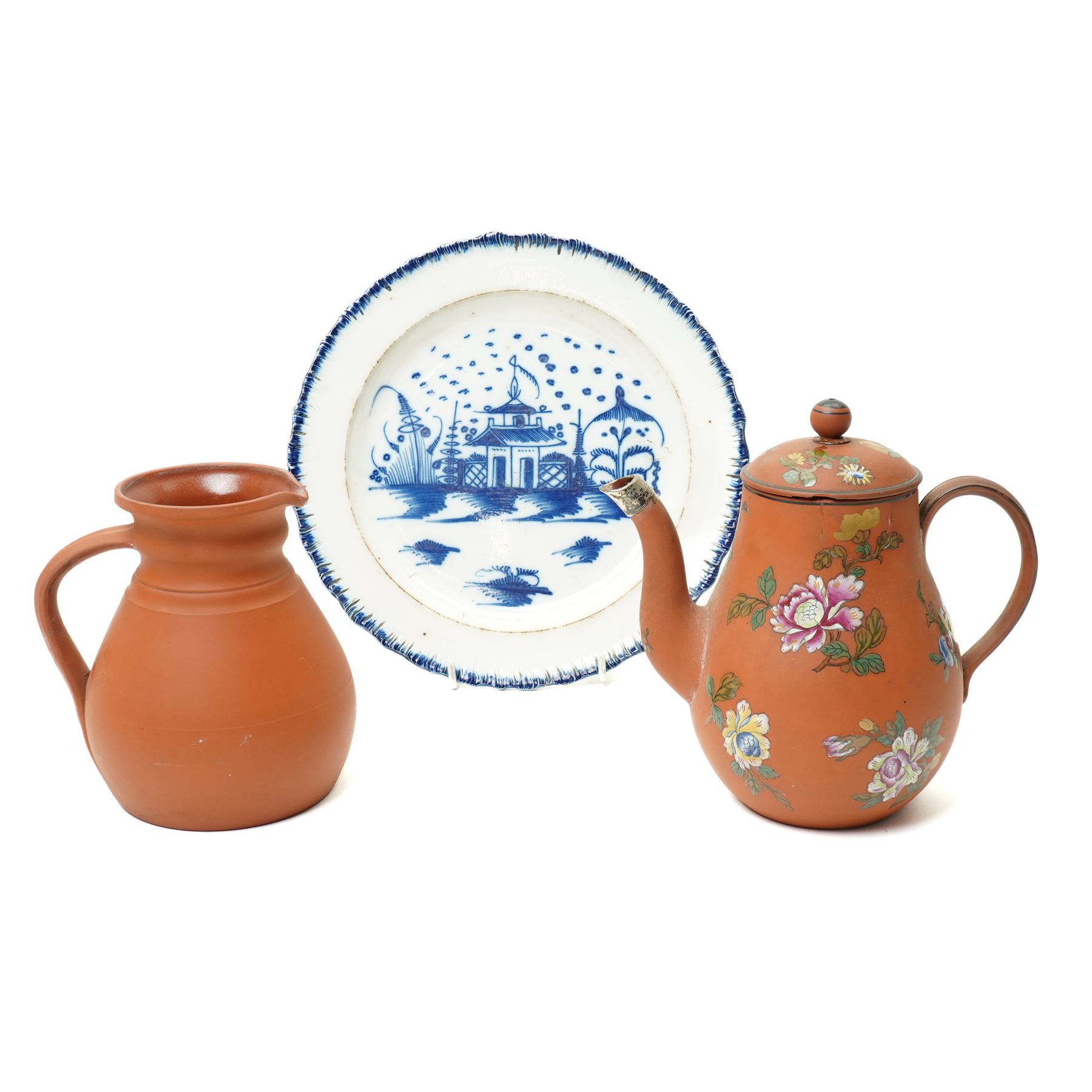 18th century creamware plate, painted with a chinoiserie landscape, D25cm; together with a Wedgwood terracotta jug, stamped to base, H15cm, and a Wedgwood Capri ware coffee pot, stamped to base, H19cm (3)