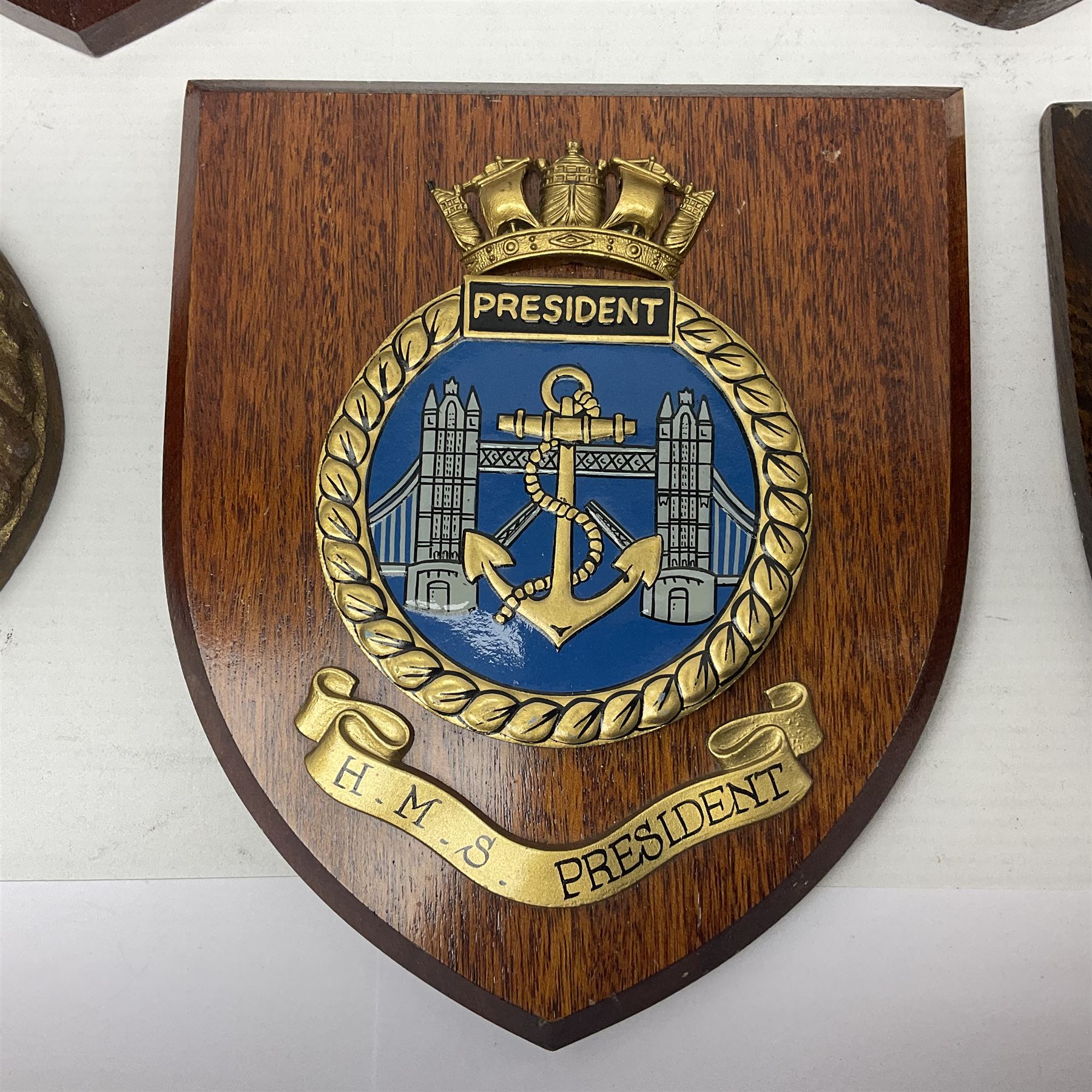 Six Naval wall shields, including HMS President, Vanguard, HMS Kilmorey etc, and another plaque 