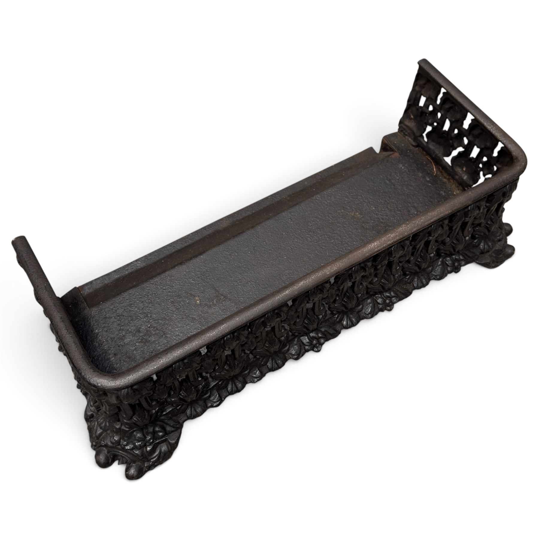 Three cast iron fireplace fittings, comprising a Regency-style fire grate with sunburst crest, urn finials, bowed basket and scroll supports (W58cm H63cm); Victorian fender with pierced acanthus frieze and foliate base (W64cm H20cm); Gothic Revival fireplace with fleur-de-lis crest, arched surround and integral fire basket (W41cm H87cm)