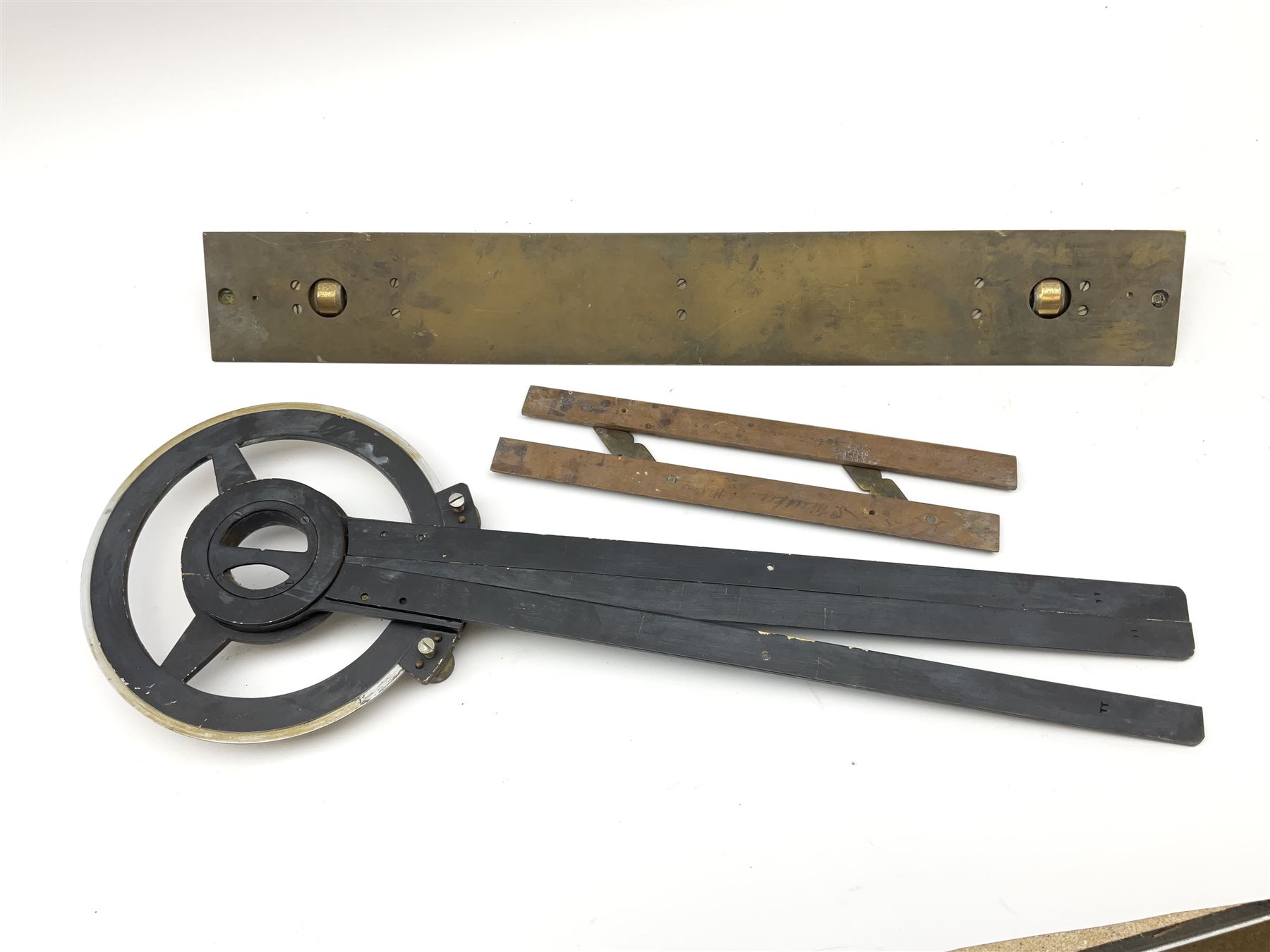 Brass and black painted maritime station pointer inscribed 6675-99-777-3202 Serial No.WMEL 0041 L45.5cm; Harling brass rolling ruler Patt.No.160100; and a parallel ruler; all unboxed (3)