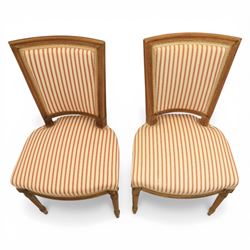 20th century Louis XVI style beech salon suite, comprising settee and four chairs, the settee with shaped rectangular back and upholstered arms over a shaped seat, the chairs with rectangular backs and overstuffed seats, each upholstered in striped fabric with close-nailed borders, upon fluted tapering supports headed by carved paterae, terminating in toupie feet, chairs H89cm W47cm