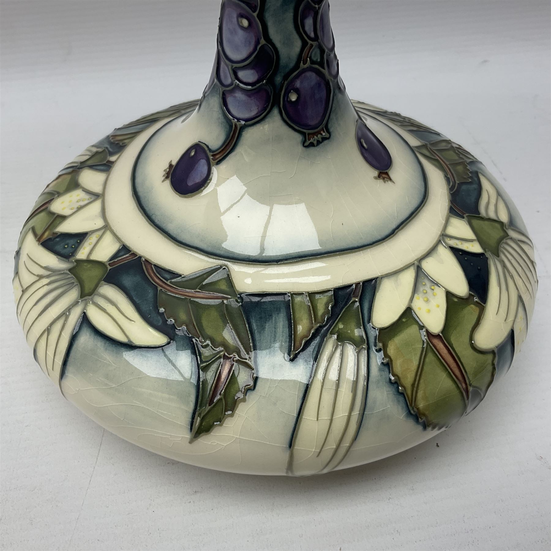 Moorcroft vase, of compressed form with a tall flared neck, decorated in the Juneberry pattern, circa 2000, H25cm