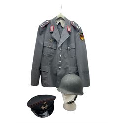 West German helmet steel helmet, together with 1960's peak cap and tunic with German insignias 