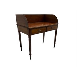 19th century mahogany desk, raised three-quarter gallery, fitted with two cock-beaded drawers, raisedon reeded supports with brass castors