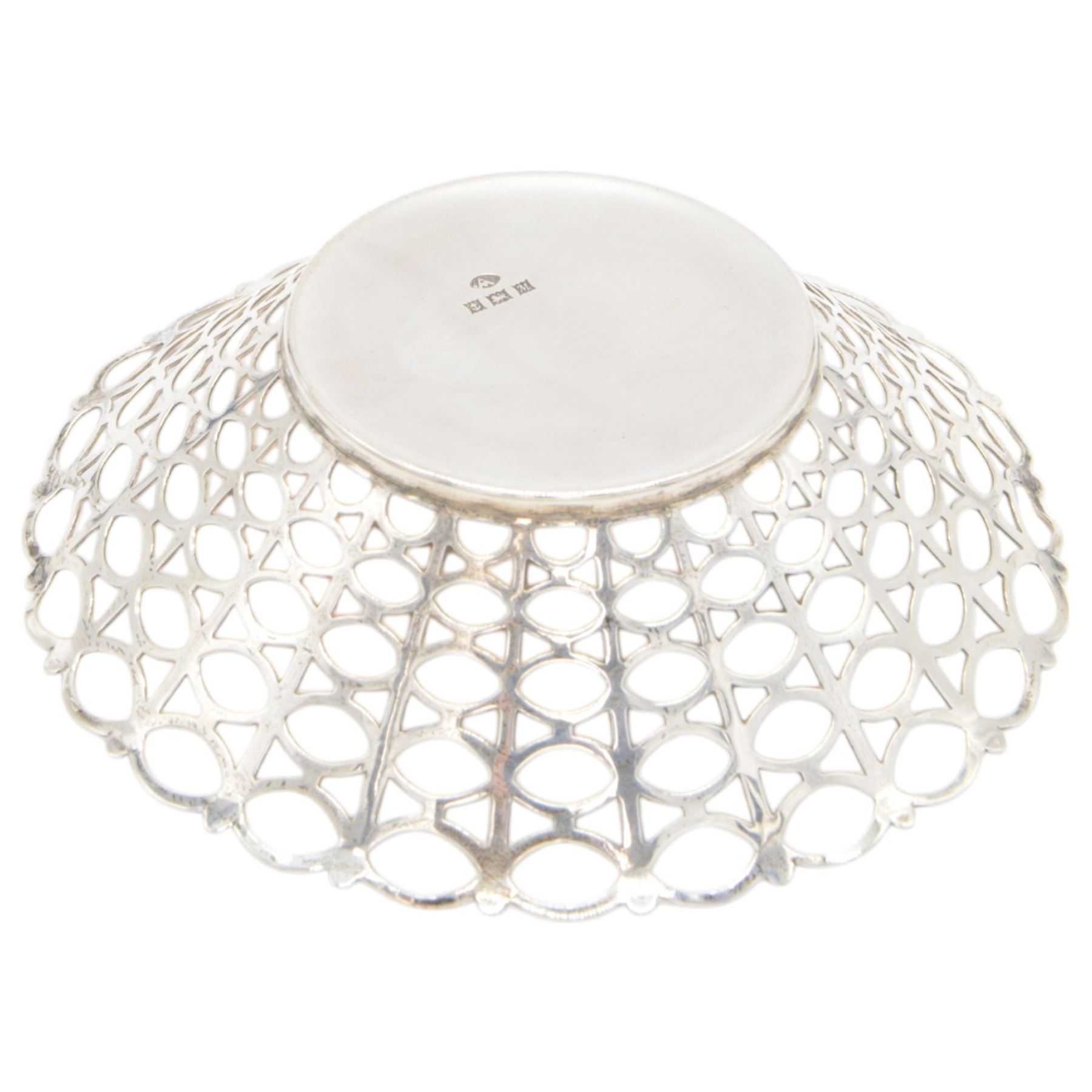 Three mid 20th century silver bowls, including two circular examples with pierced sides and a square example with twin handles, all hallmarked