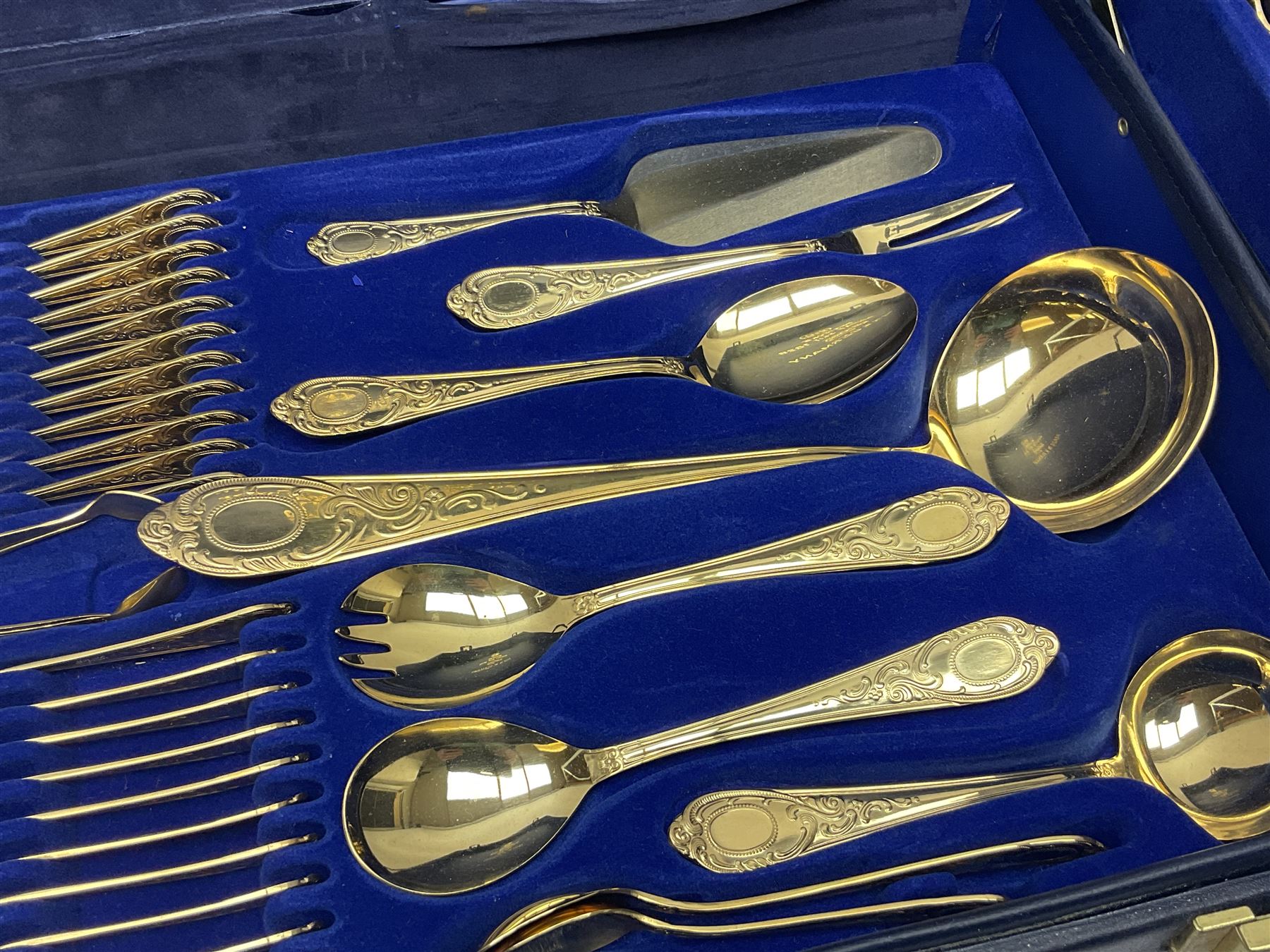 Bestecke Solingen canteen of gold plated cutlery for twelve place settings, including ladle, cake slice, fish servers, fish knives and forks, 108 pieces total, contained within a briefcase 