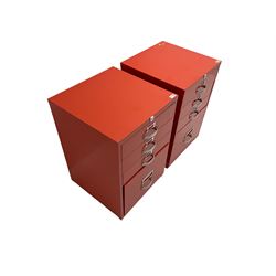 Two red finish 'Bisley' four drawer filing cabinet
