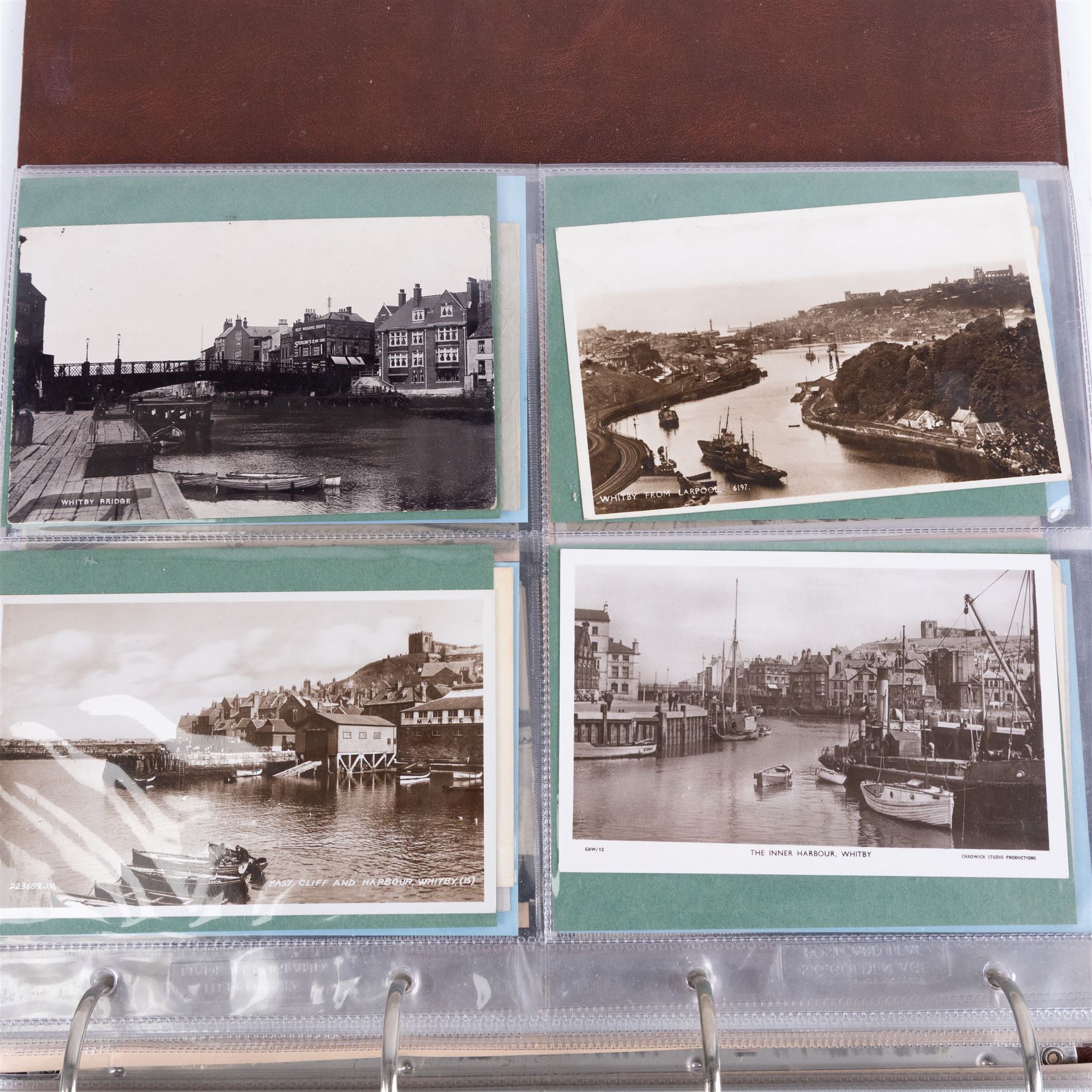 Two-hundred and thirty eight early 19th century to 20th century Whitby view postcards, including twenty-four early 19th century court cards, seventeen views of Whitby Abbey, forty depicting the fishing fleet and harbour, with a selection of cards providing a detailed study of the early 'Yards' the fisherman's dwellings around the harbour, all housed within a Stanley Gibbons Picture Postcard Album
