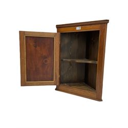 Mahogany wall hanging corner cupboard of small proportions, enclosed by unusual figured and fielded panel door