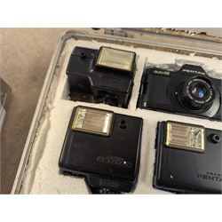 Two Pentax Auto 110 camera bodies and accessories including flashes, winder and lenses, all within two flight cases