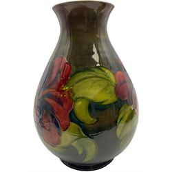 Moorcroft vase of bulaster form, decorated in Hibiscus pattern upon a green ground, H21cm 