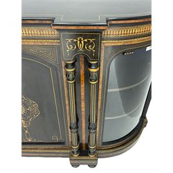 Victorian ebonised and inlaid credenza, break-front with curved ends, the front fitted with two curved glazed doors and central panelled door, inlaid with scrolling foliate and star motifs, quadruple turned and fluted pilasters to front, gilt egg and dart moulded edge on plinth base with figured walnut band, on turned feet
