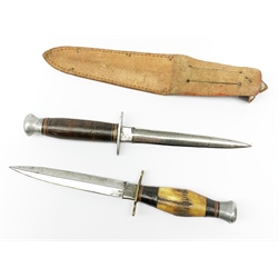 American WW2 type fighting knife with 15cm steel double edged blade, aluminium crosspiece and pommel and leather bound grip, in leather sheath marked Sheffield England L27cm overall; and another similar fighting knife with antler grip and no sheath (2)