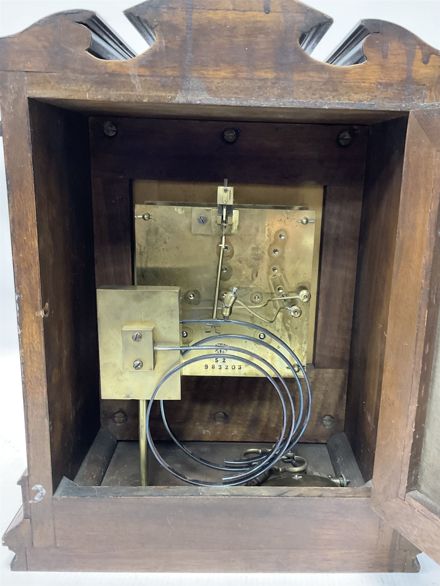 Lenzkirch - Late 19th century 8-day German mantle clock in a walnut veneered case with an architectural pediment, square brass dial, cast spandrels, matted dial centre, silvered chapter ring and fleur-di-Lis hands, with a twin train movement chiming the quarters on two coiled gongs and striking the hours on one. With Key and pendulum. Silver presentation plaque dated 1896.