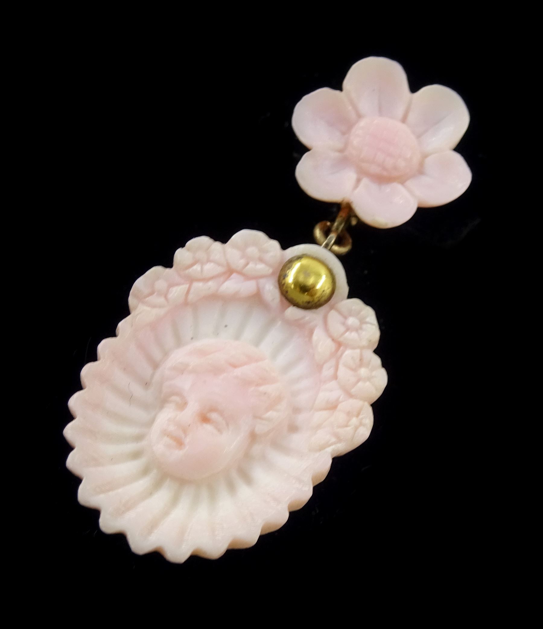 19th century gold conch shell pendant / brooch and matching earrings, each with carved bust shell of a cherub / child and flower head decoration, the earrings suspending a further flower head stud