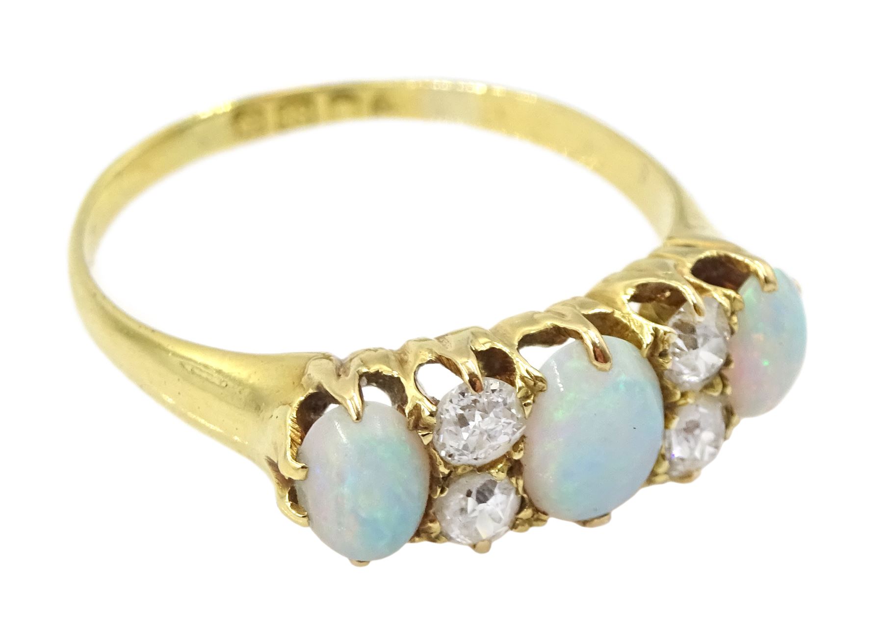 Early 20th century 18ct gold three stone opal, the centre stone set with two old cut diamonds either side, London 1913, total diamond weight approx 0.30 carat