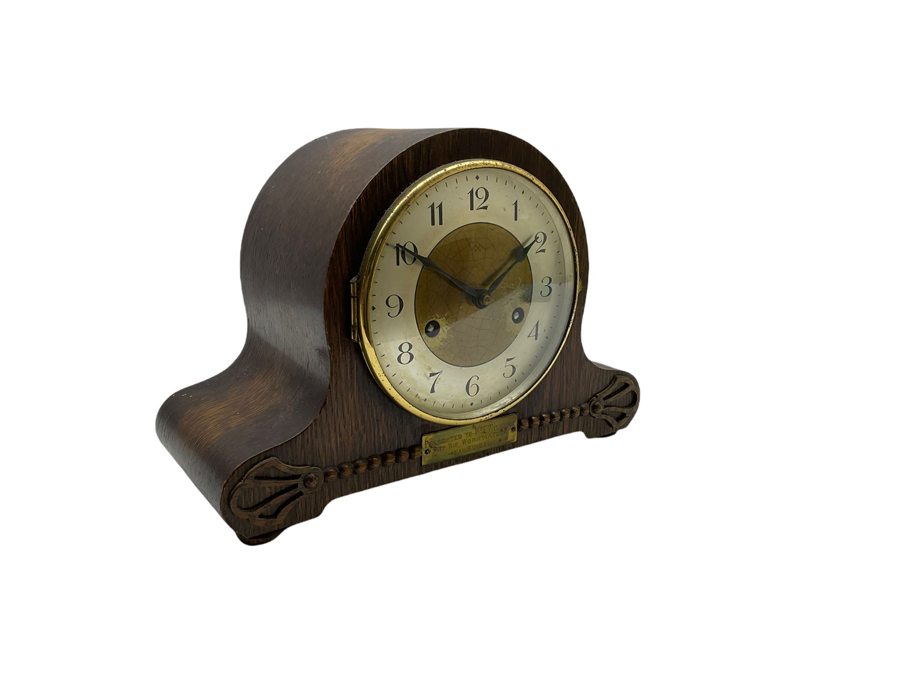 An oak cased 1930’s eight-day German mantle clock manufactured by HAC (Hamburg Amerikanische Uhrenfabrik), spring driven movement with a recoil anchor escapement striking the hours and half hours on a coiled gong, in round case with silvered chapter ring with Arabic numerals and minute markers, steel spade hands within a brass bezel and convex glass. With a presentation plaque to the front of the case. With pendulum.


