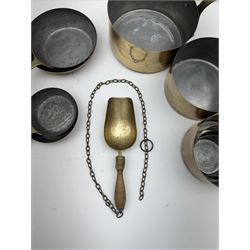 Sets of four graduating copper frying pans, together with a set of six graduating saucepans