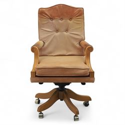 Late 20th century swivel executive desk chair, upholstered in tan leather with brass studded trim, raised on five point base raised on castors 