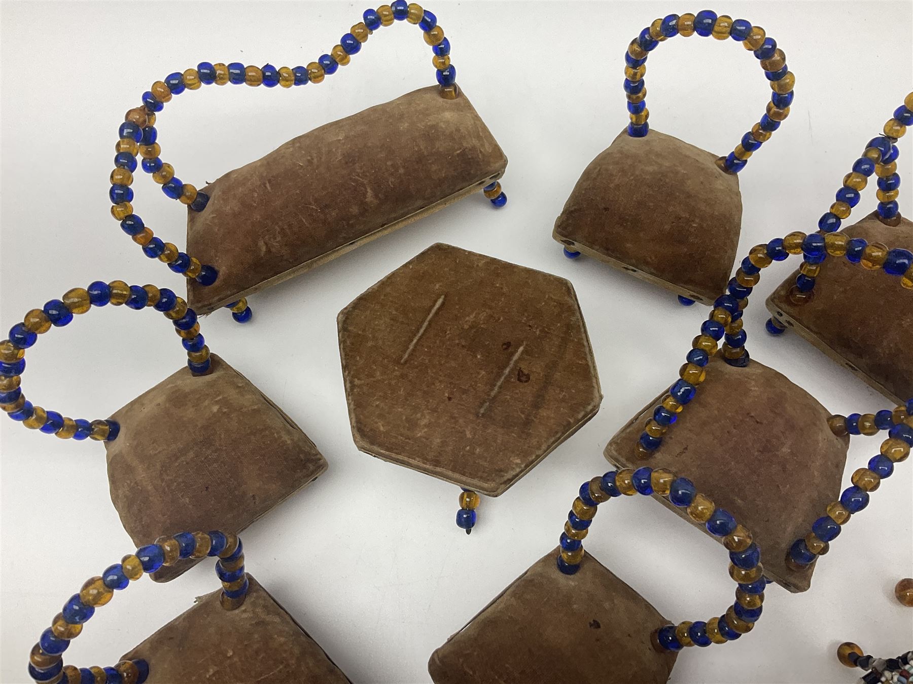 Quantity of early 20th century doll's house furniture comprising Victorian style beadwork and upholstered eight-piece salon suite; beadwork dining table with four matching chairs; and Kleeware brown plastic seven-piece dining suite