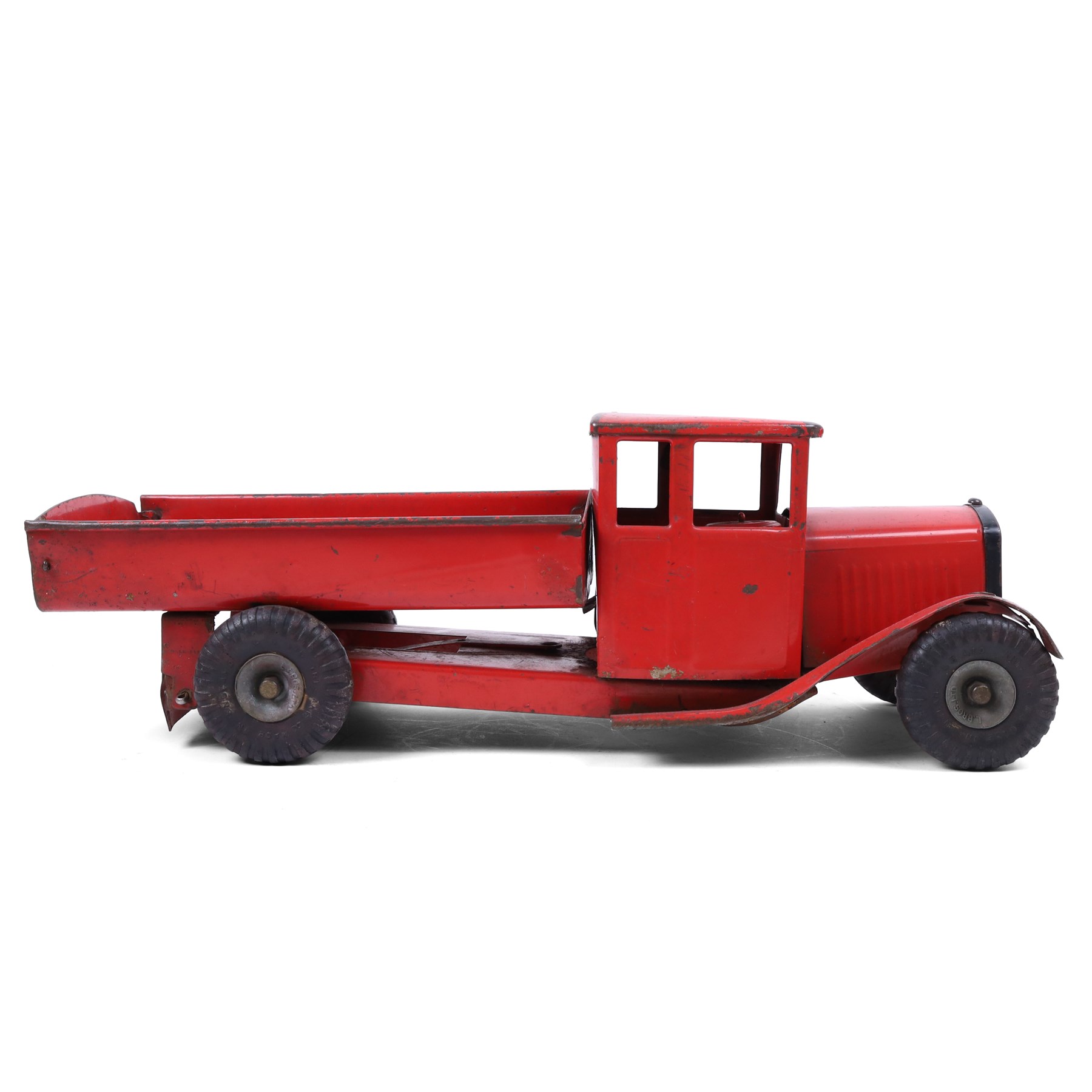 Tri-ang/Line Bros Ltd tin plate tipper truck, red body with black rubber wheels and red seat and steering wheel to interior, H49cm, L16cm