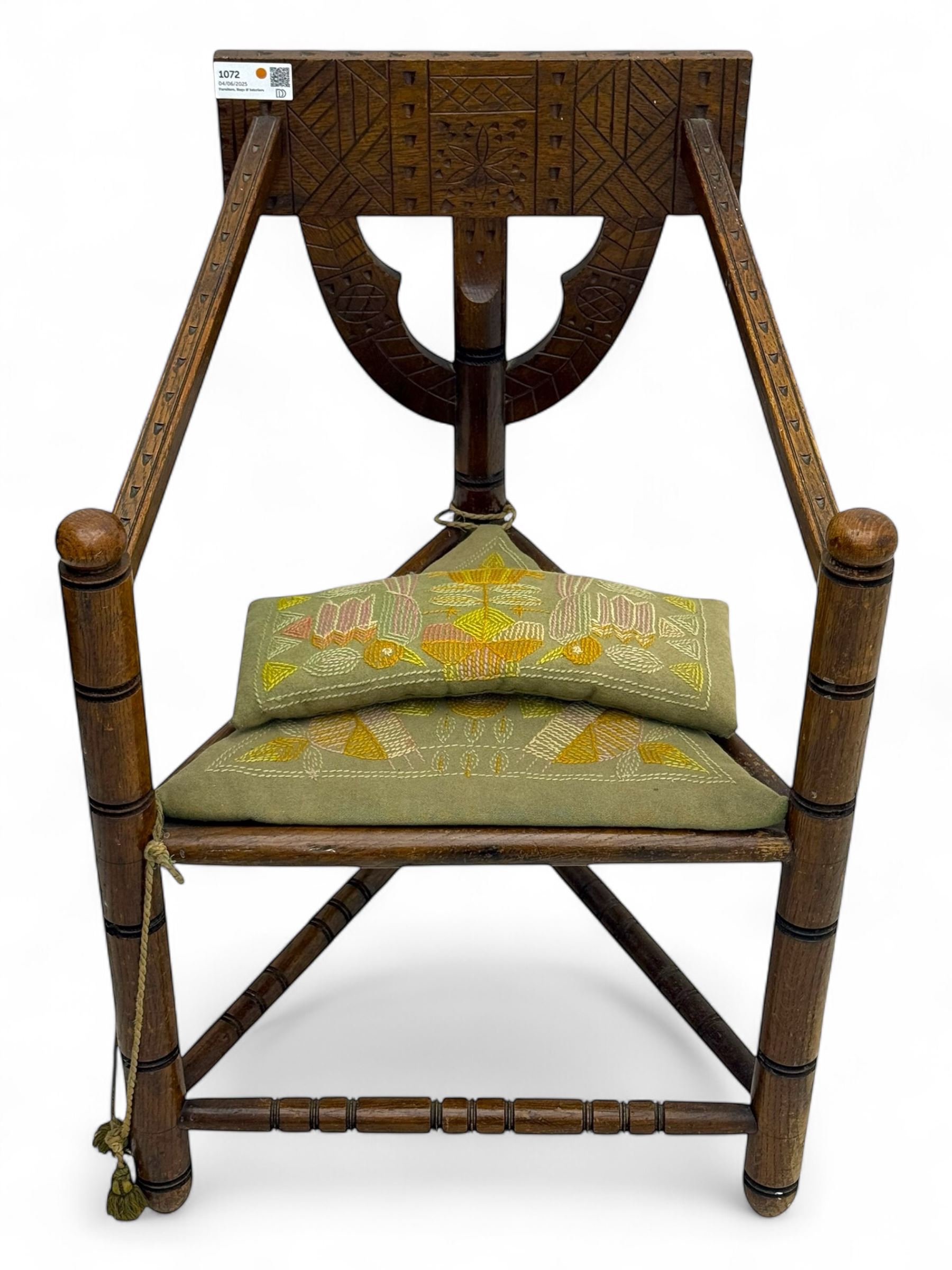 19th century swedish monk's chair, the oak frame with triangular seat and sloped arms, the backrest carved with geometric chipwork and a central pierced medallion 