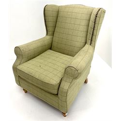 Next Sherlock wingback armchair upholstered in a light green chequered fabric, turned supports 