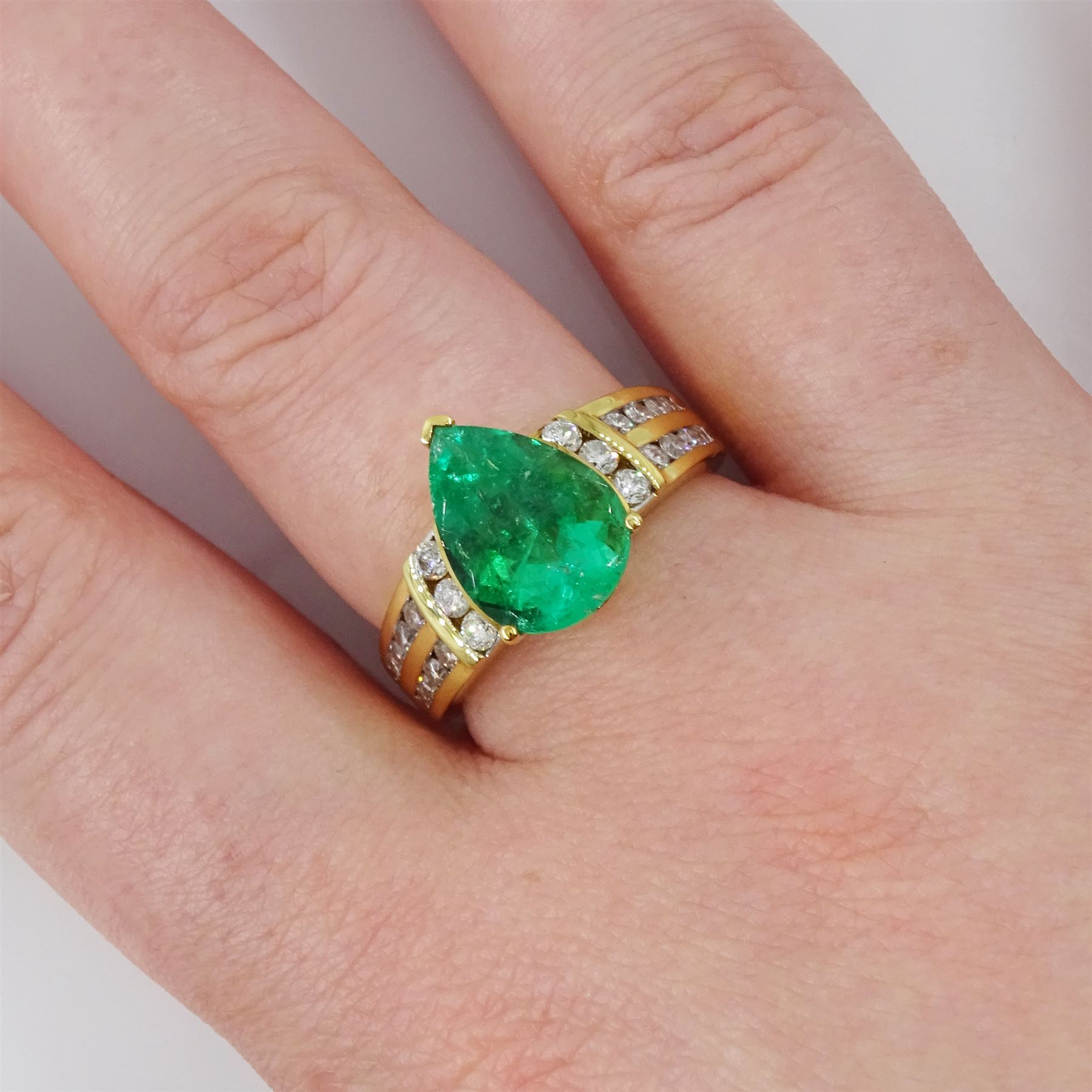 18ct gold Colombian emerald and diamond ring by Iliana, single pear cut emerald of approx 3.25 carat, with three round brilliant cut diamonds set either side and diamond set shoulders, hallmarked, total diamond weight 0.53 carat