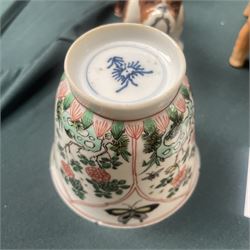 Three Chinese famille verte examples, approximately Yongzheng period, to include two teabowls and two saucers, each decorated with flowers and butterflies, two with sacred fungus mark within double rings, the teabowl with lotus mark, the other indistinct - possibly a Wan mark within lozenge (4)