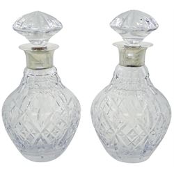 Pair of modern silver mounted Royal Doulton cut glass decanters, of ovoid form with domed stoppers, the plain silver mounted collars hallmarked J B Chatterley & Sons Ltd, Birmingham 1984, H24cm
