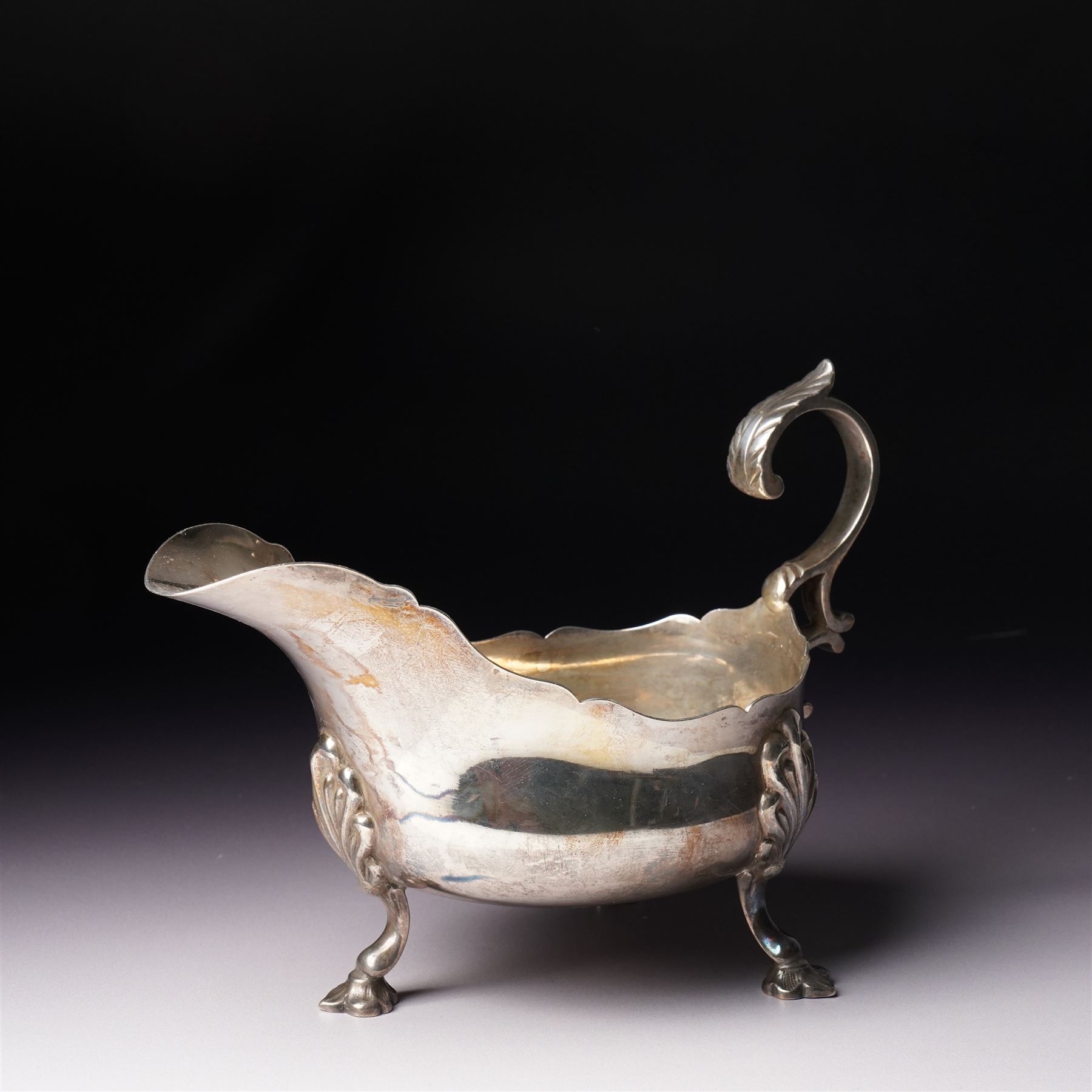 Late Victorian silver sauceboat with crimped rim, C scroll handle on shaped supports Sheffield 1899 Maker Martin Hall & Co, retailed by Allen & Daws, Norwich