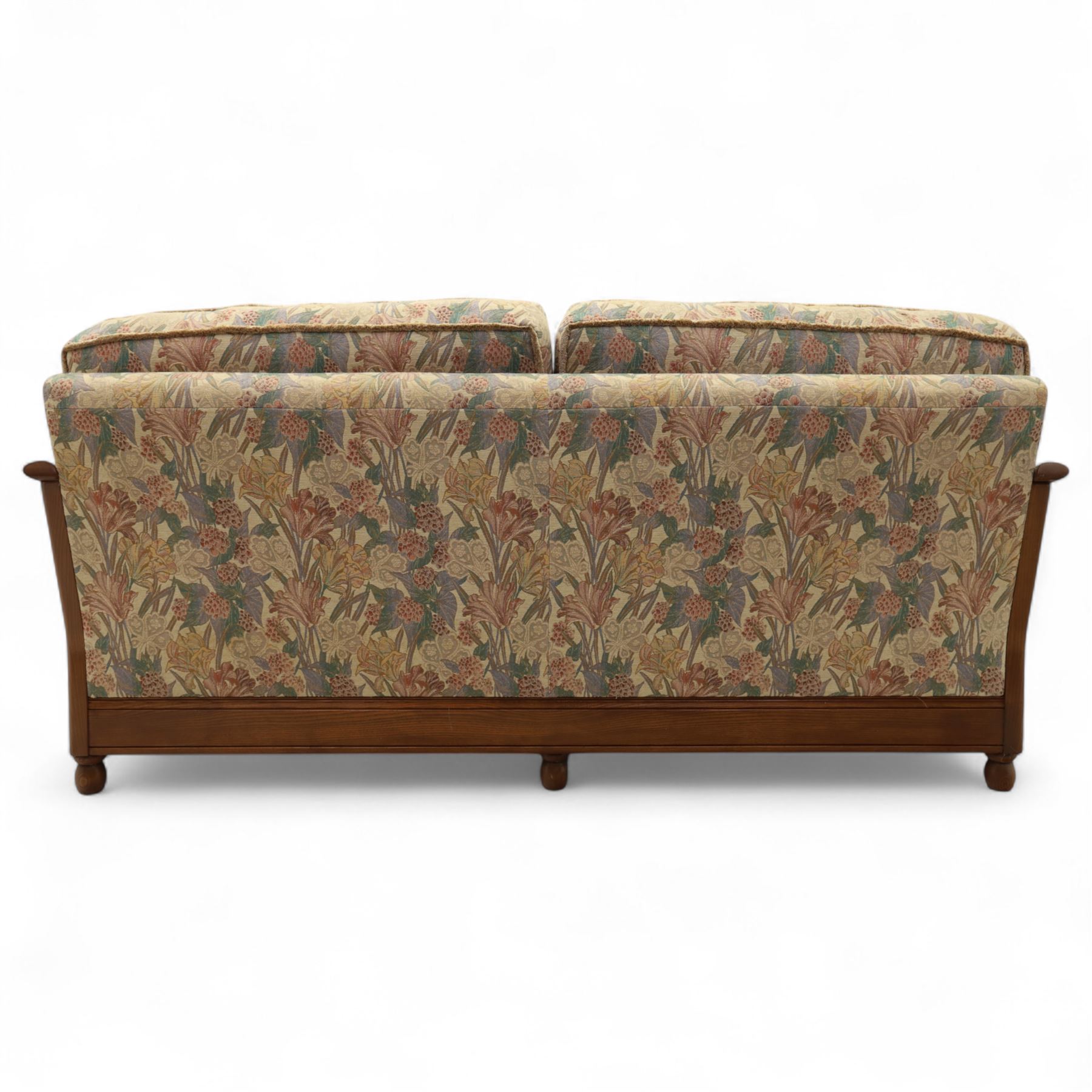 Ercol – bergère four piece suite, including armchair, two seat sofa, three seat sofa and footstool, all with removable floral upholstered cushions, the frames with side caning and rounded arm supports in stained beech

Three seat (H 87cm, D 89cm, W 196cm)
Two seat (H 87cm, D 89cm, W 137cm)
Armchair (H 87cm, D 89cm, W 87cm)
Footstool (H 28cm, D 55cm, W 55cm)