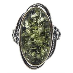 Silver oval green Baltic amber ring, with leaf detail to gallery, stamped 925 