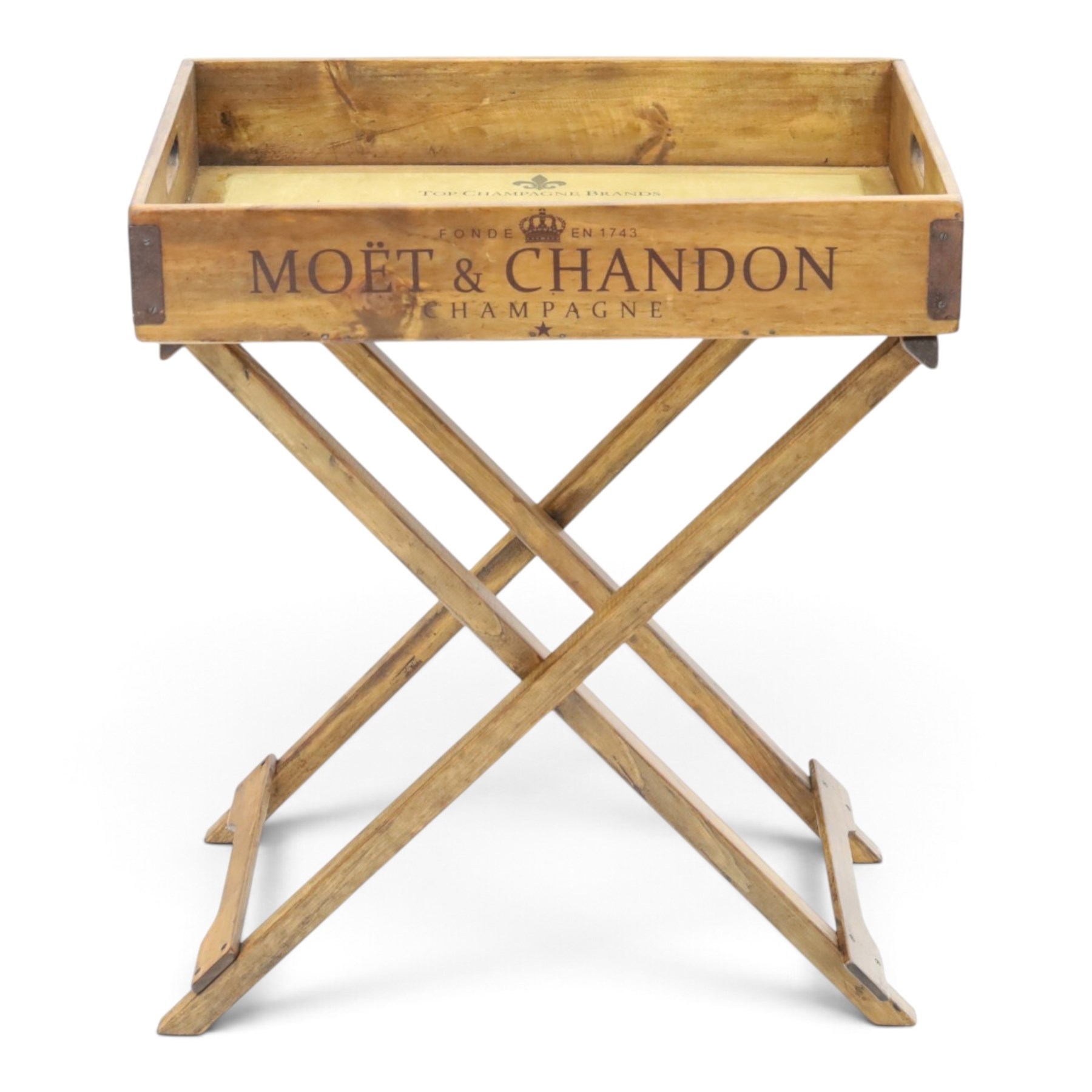 Champagne butler’s tray on stand, the wooden tray printed with champagne bottles and brand names, with cutout handles, raised on a folding stand
