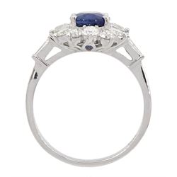 18ct white gold oval sapphire and round brilliant cut diamond cluster ring, with tapered baguette cut diamond shoulders, stamped 750