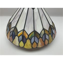 Tiffany style lamp shade, of oval form, with pale peach flowers on a cream and orange lattice ground, together with three other Tiffany style lamp shades and a moulded glass lamp shade with four coloured panels, oval Tiffany style W28.5cm