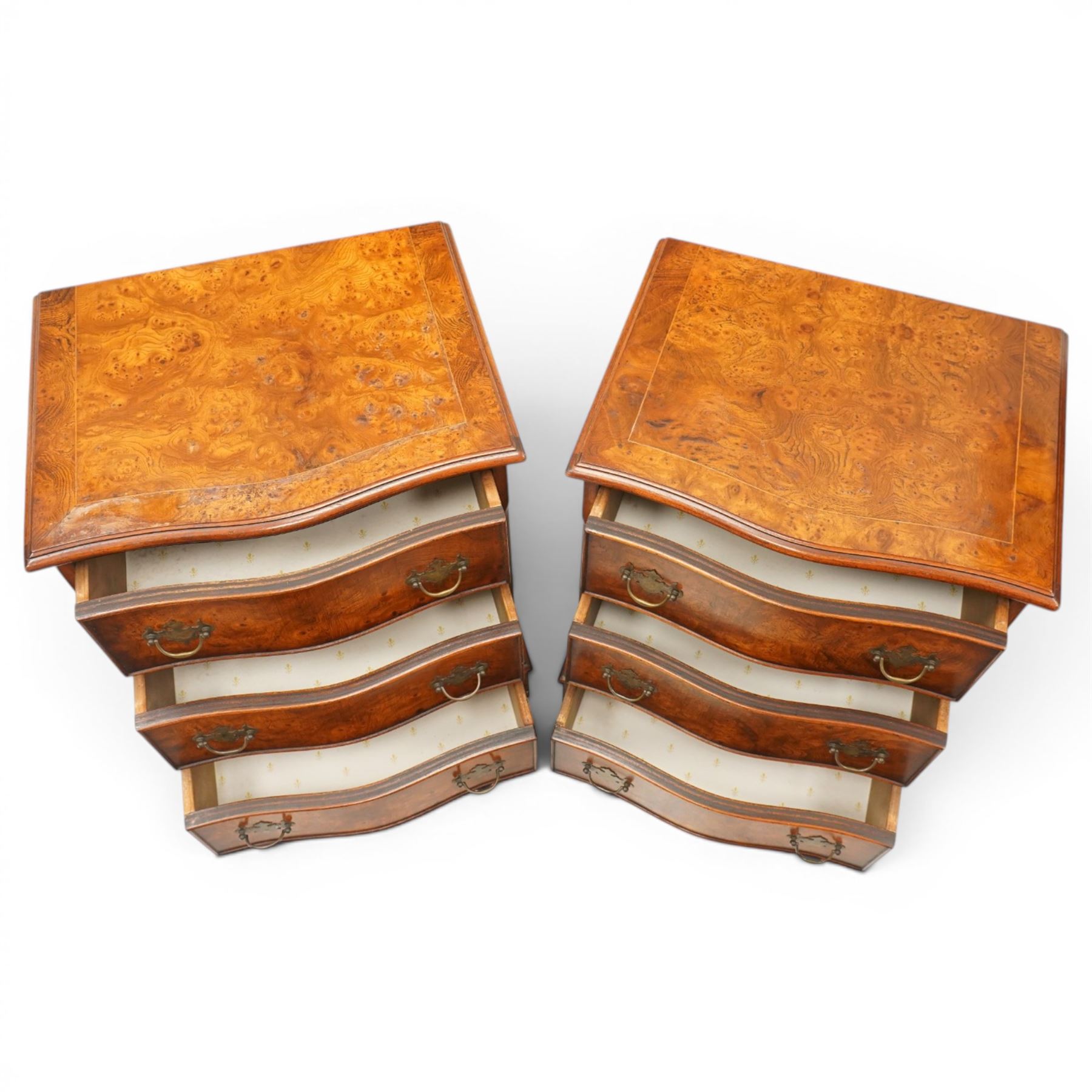 Pair of Georgian design figured elm serpentine bedside chests, moulded top raised on bracket feet