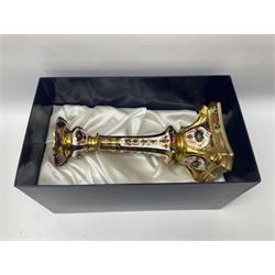 Pair of modern Royal Crown Derby Old Imari 1128 pattern candlesticks, each with shaped drip tray affixed to squat socket, upon spreading stem and canted square base with gilt dolphin edges, with printed marks beneath including Roman numeral year cypher for 2003, H26.5cm, with original boxes